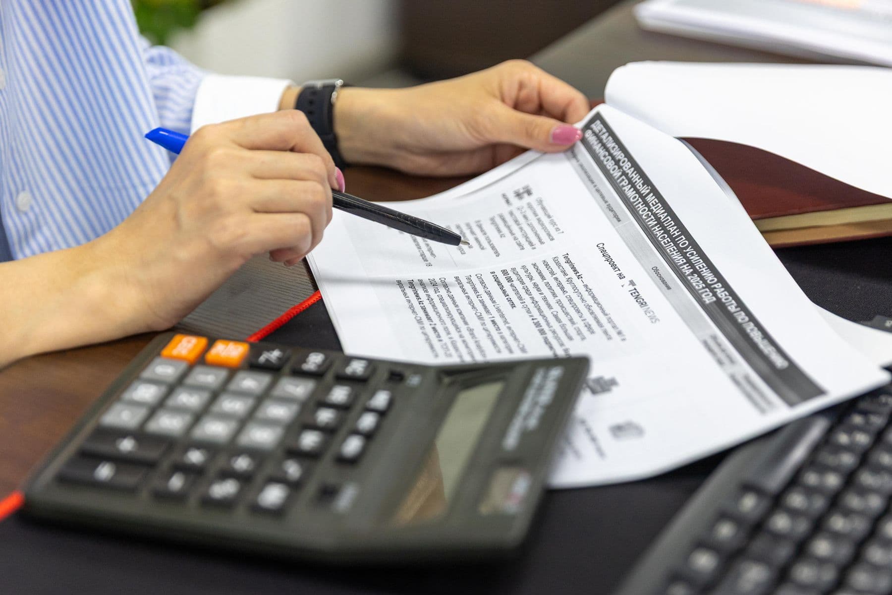 A calculator resting on financial working papers